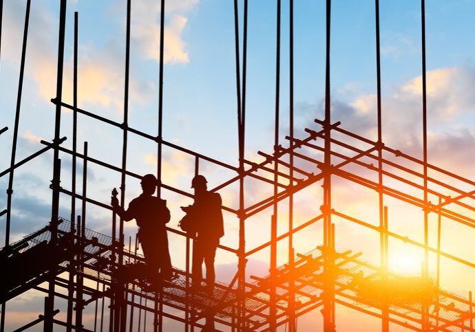 construction worker on construction site at sunset